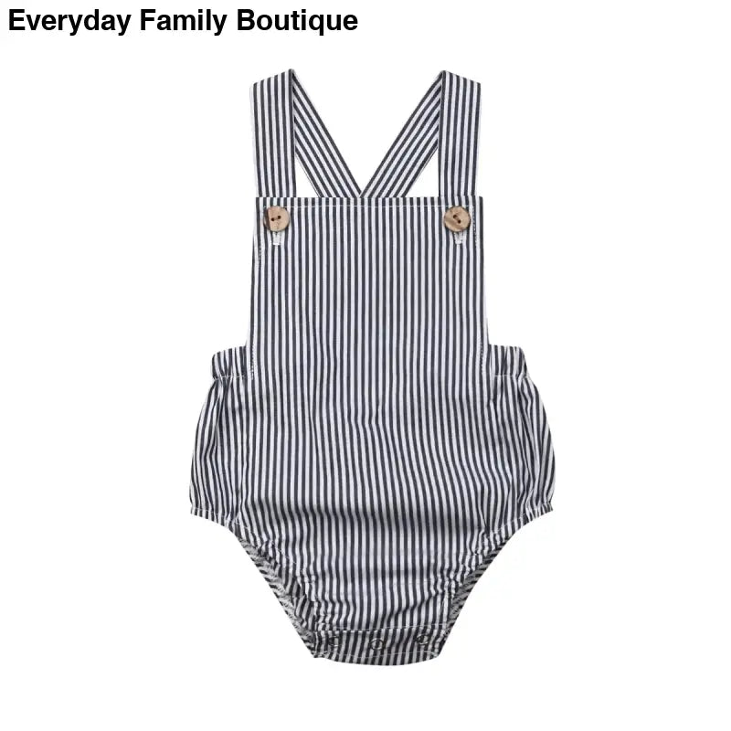 Striped baby romper with crossed shoulder straps and button fasteners.